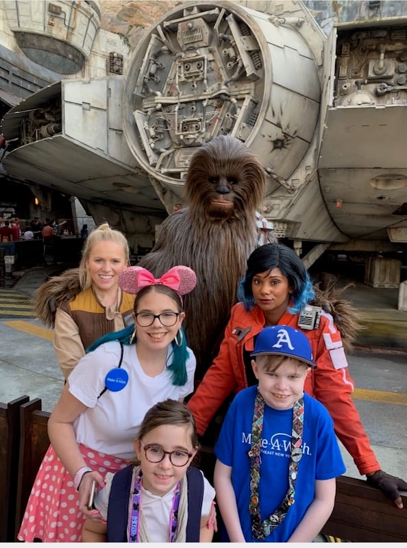 Ella, Riley, and Victoria posing with Chewbacca and other Star Wars characters.
