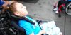 Olive in her wheelchair, wearing a Little Lobbyists shirt. 