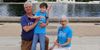 A smiling Charlie and his parents at the U.S. Capitol. 
