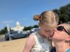Emma and her daughter snuggling outside the US Capitol