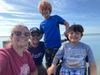 The Witzler family grins on a day at the beach.