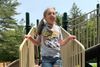 Audrey Anderson smiling broadly while standing on a playground structure. 