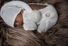 A mixed-race infant sleeping on a furry blanket.