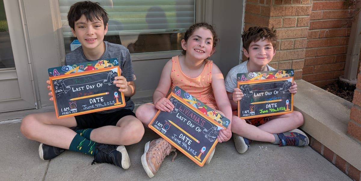 Liviana and her two siblings beaming on the last day of school. 