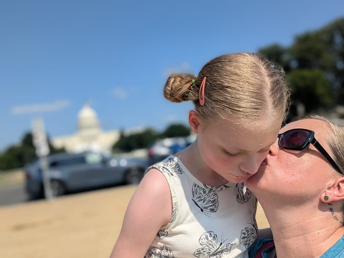 Emma and her daughter snuggling outside the US Capitol