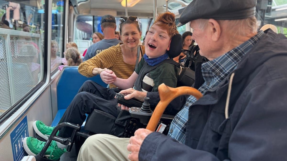 Danny Robeson on a bus with his family, looking out the window.