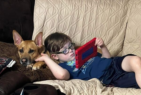Cole and a canine friend lounging on the couch