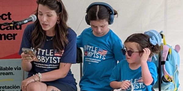 Alexis and her family speak at a rally. 