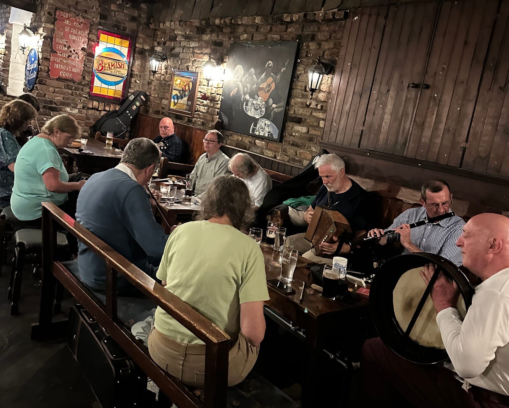 Musicians gather in a designated area around three long tables.  There's banjo, fiddle, accordion, flute, concertina and bodhran.
