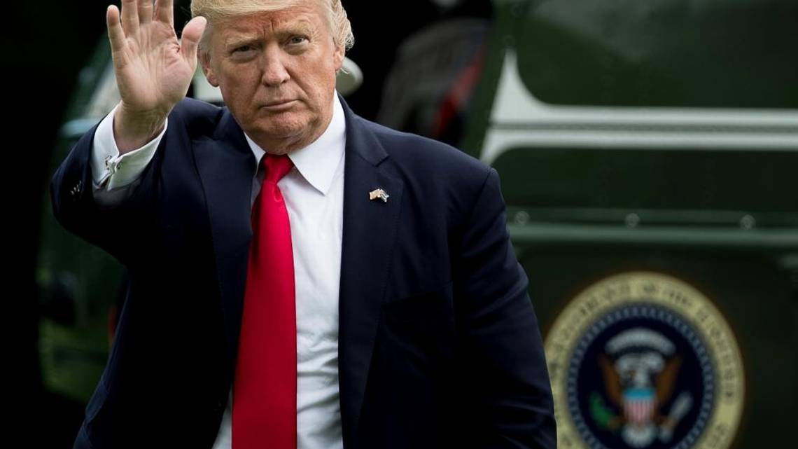 President Donald Trump waves as he arrives on the South Lawn at the White House in Washington, Friday, June 16, 2017, after speaking about Cuba policy in Miami.