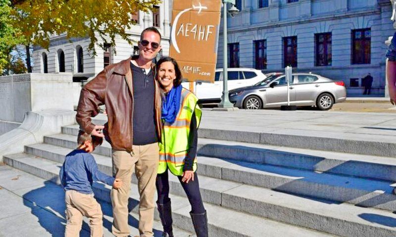 Stephanie and Kyle Atteberry, both United Airlines pilots, with their son Aaron, 4, attend a medical freedom rally in Harrisburg, Pa., on Nov. 9, 2021. (Beth Brelje/ The Epoch Times) 