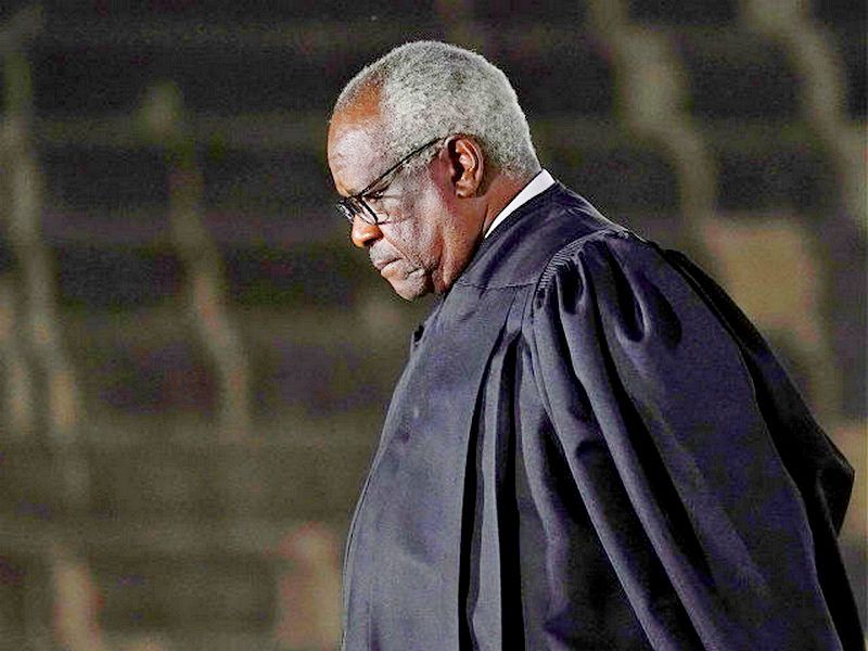 Supreme Court Justice Clarence Thomas listens as President Donald Trump speaks before administering the Constitutional Oath to Amy Coney Barrett on the South Lawn of the White House in Washington, Monday, Oct. 26, 2020, after she was confirmed by the Senate earlier in the evening. (AP Photo/Patrick Semansky)
