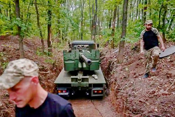 Ukrainian Soldiers inspect a dated C-60 artillery gun they just repaired.