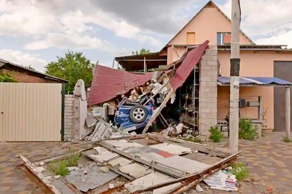 A damaged house marks a road on the outskirts of Mala Rohan.
