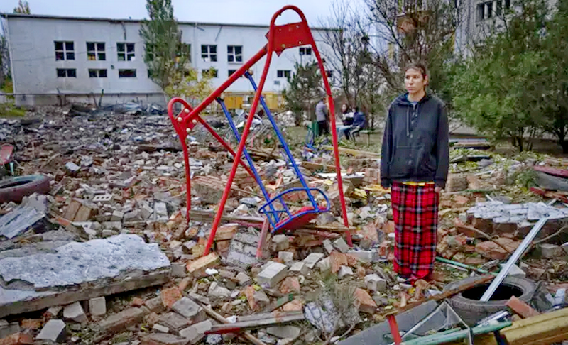 Taisiia Kovaliova, 15, stands amongst the rubble of a playground in front of her house hit by a Russian missile in Mykolaiv, on 23 October.