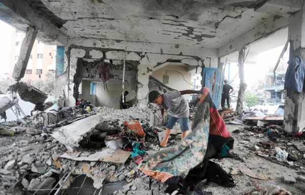 A child in the debris of a partially destroyed building