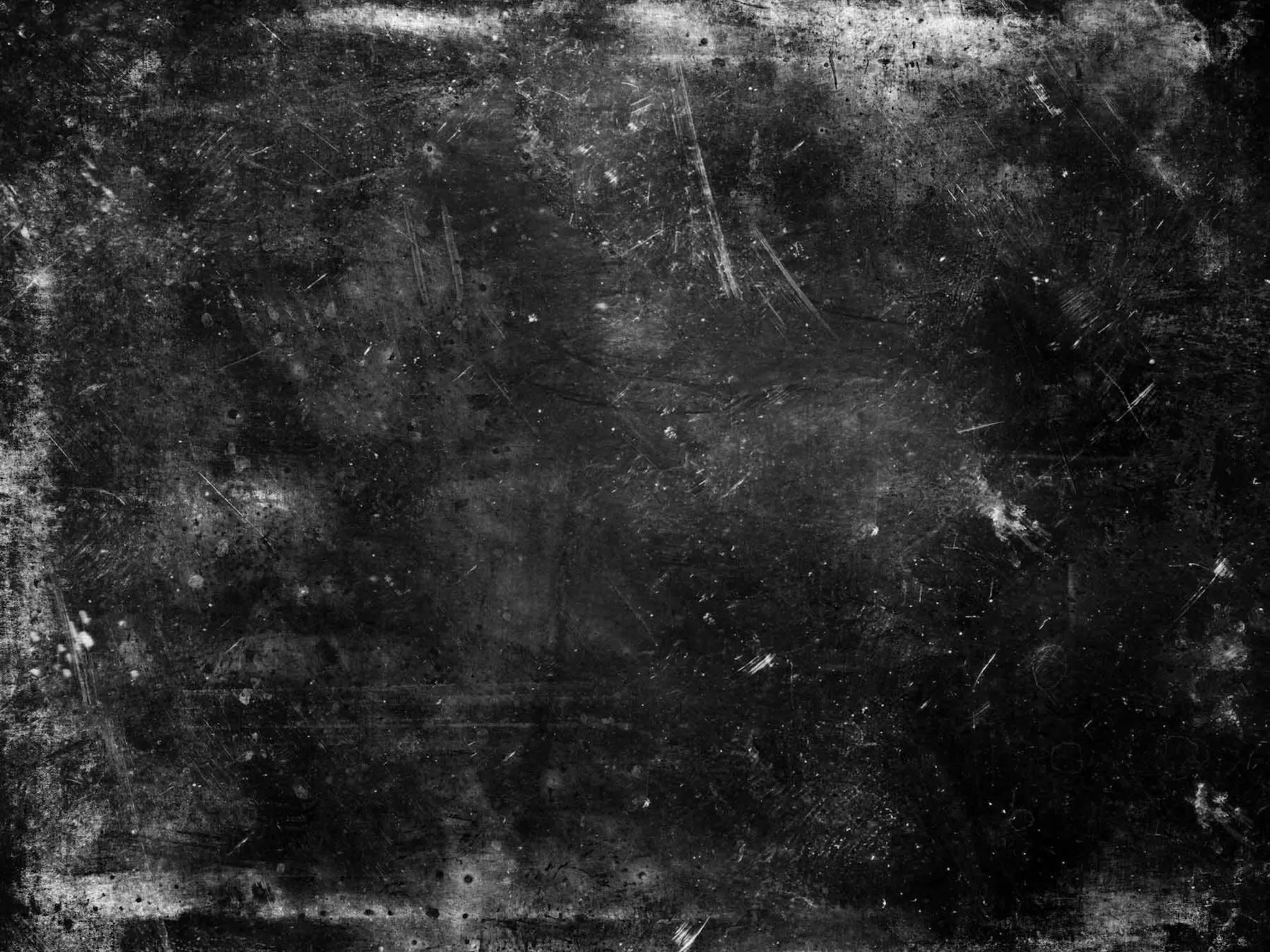 Abstract black and white photo of a textured concrete wall.