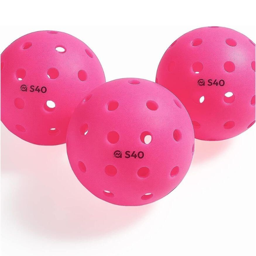 set of three pink pickleballs