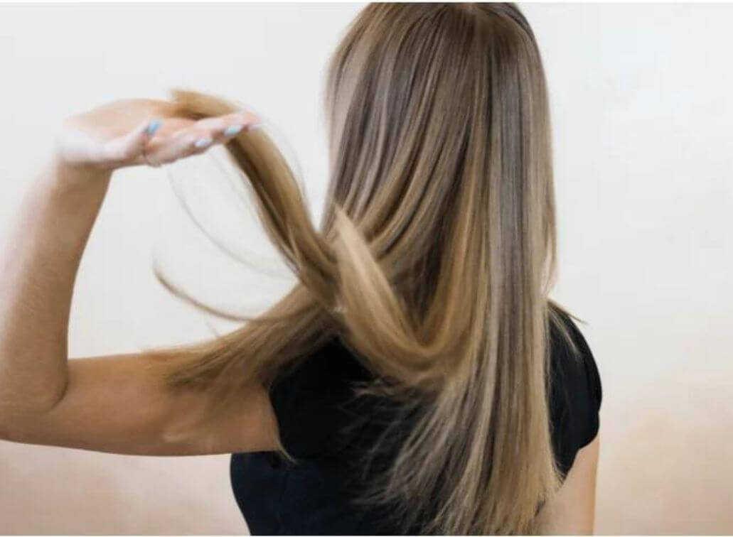 lady with black shirt and back of head flipping blonde hair