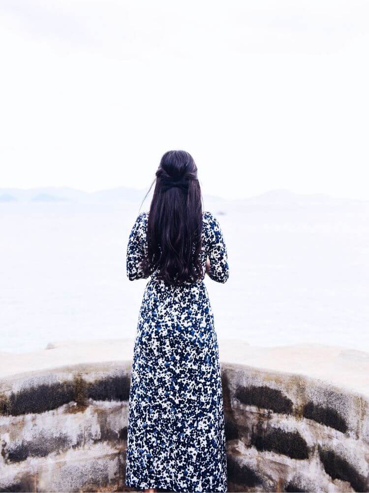woman overlooking water with cuban twist hair