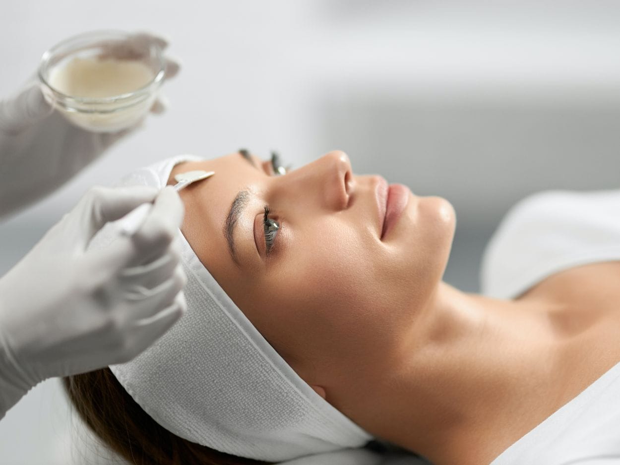 woman at spa getting face treatment