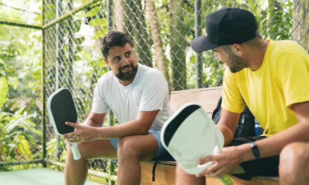 two men talking after a pickleball game