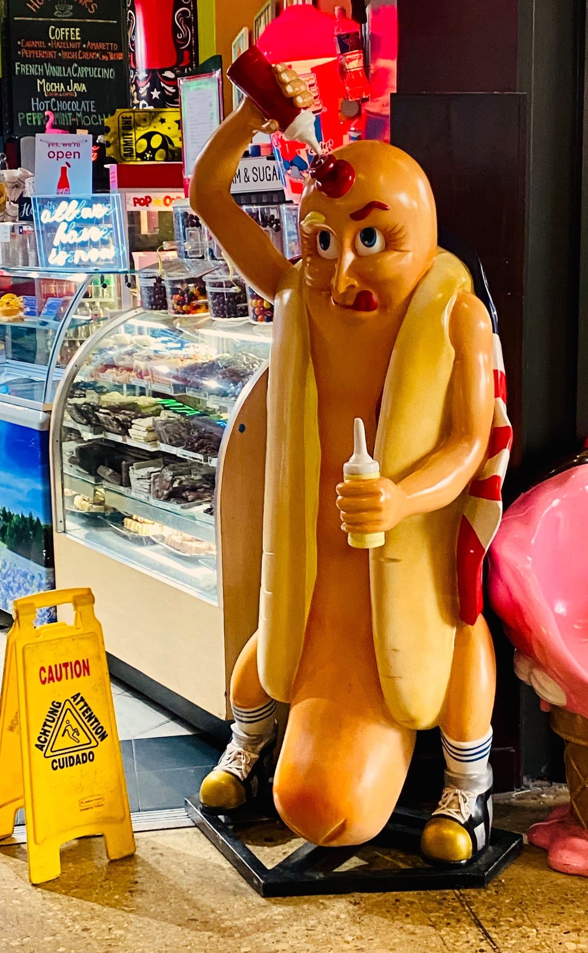 Photo of a human sized hot dog squirting catsup on themself (found in San Antonio)