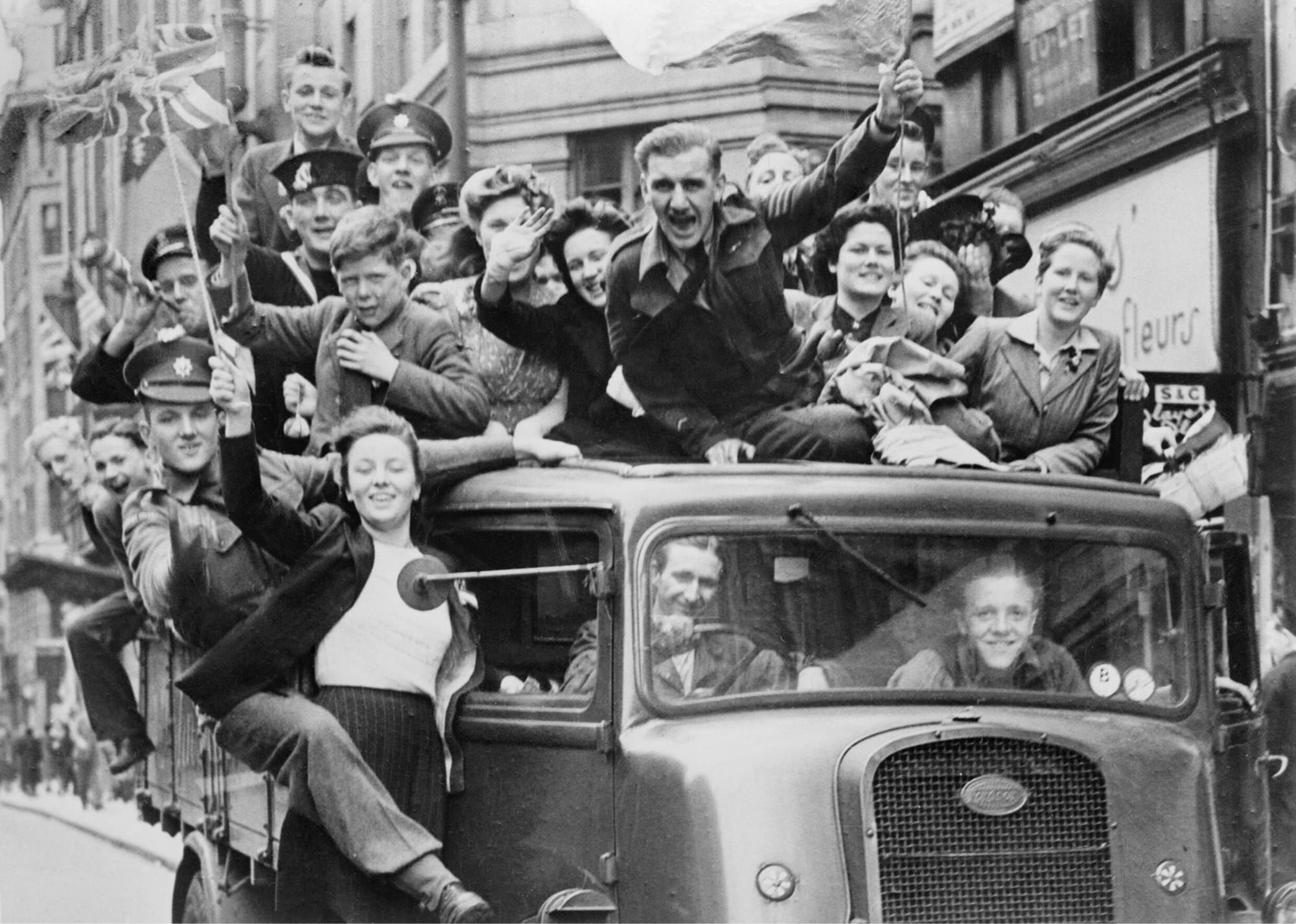 A truck of revellers passes through the Strand, London on VE Day 1945
