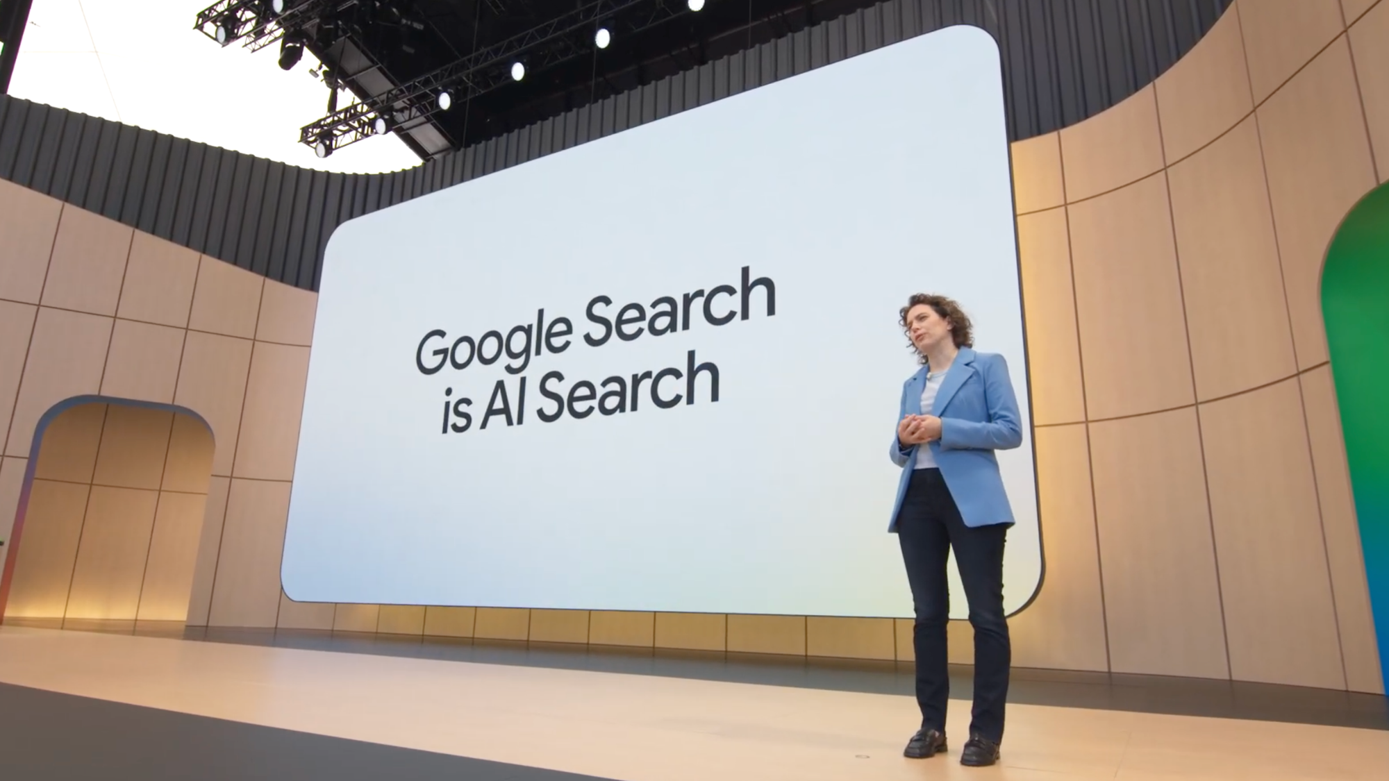 Google executive standing in front of screen that says Google Search is AI Search