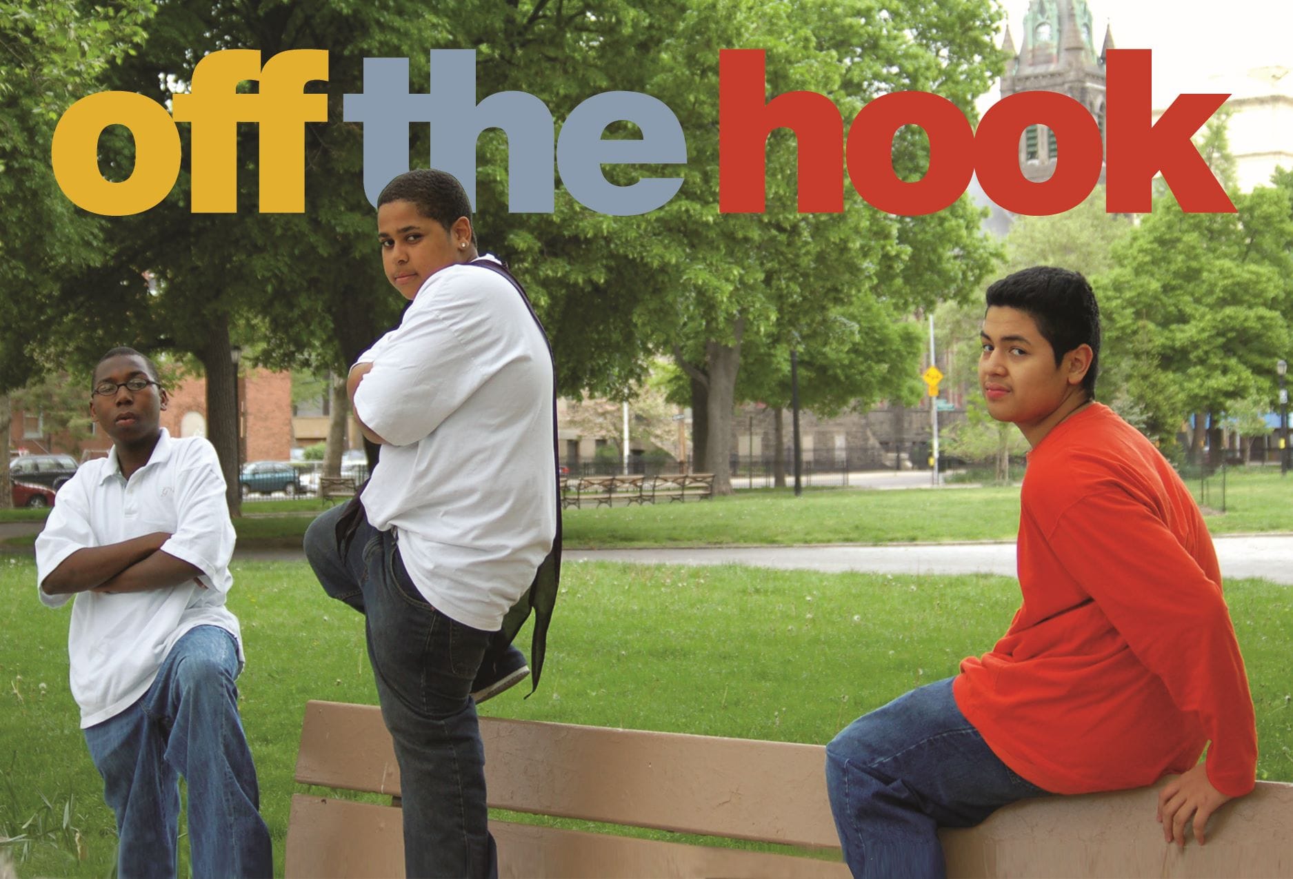 A postcard for an Off the Hook performance, featuring three young men arranged on a park bench.