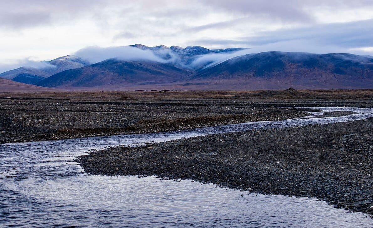 the mouth of a river on Wrangel Island, with fog spilling over mountains
