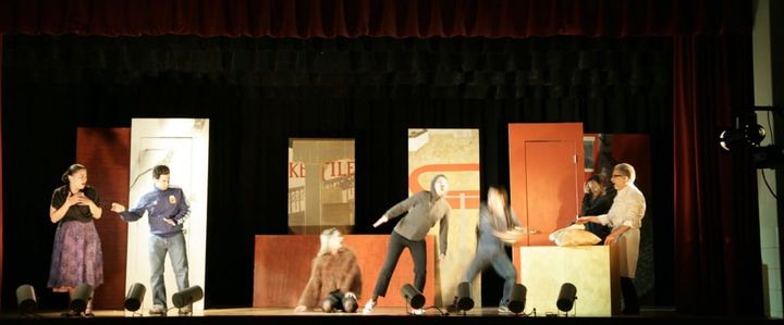 An image of a play, blurry indistinct, something is happening but it's unclear what. You had to be there.