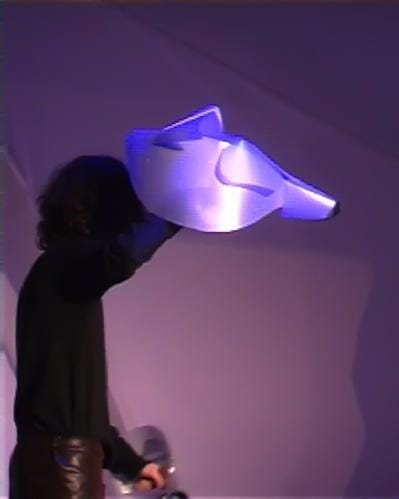 A person holding a light up head

Description automatically generated
