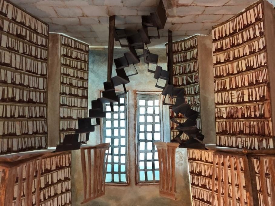 A spiral staircase in a room

Description automatically generated