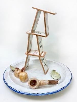 A stack of cards on a plate

Description automatically generated