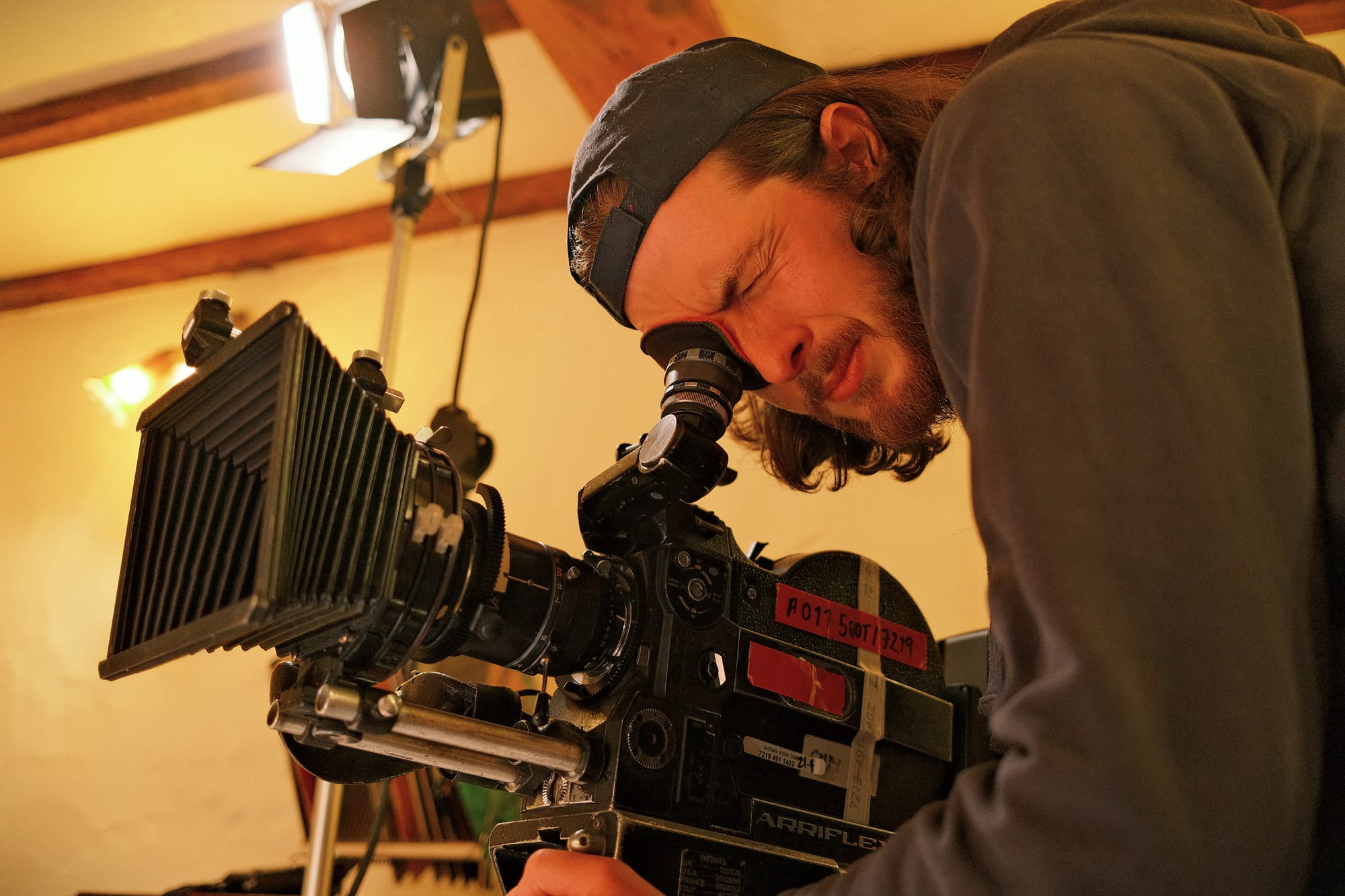 Zander Weaver looking through a film camera while shooting Nightstone in 2025.