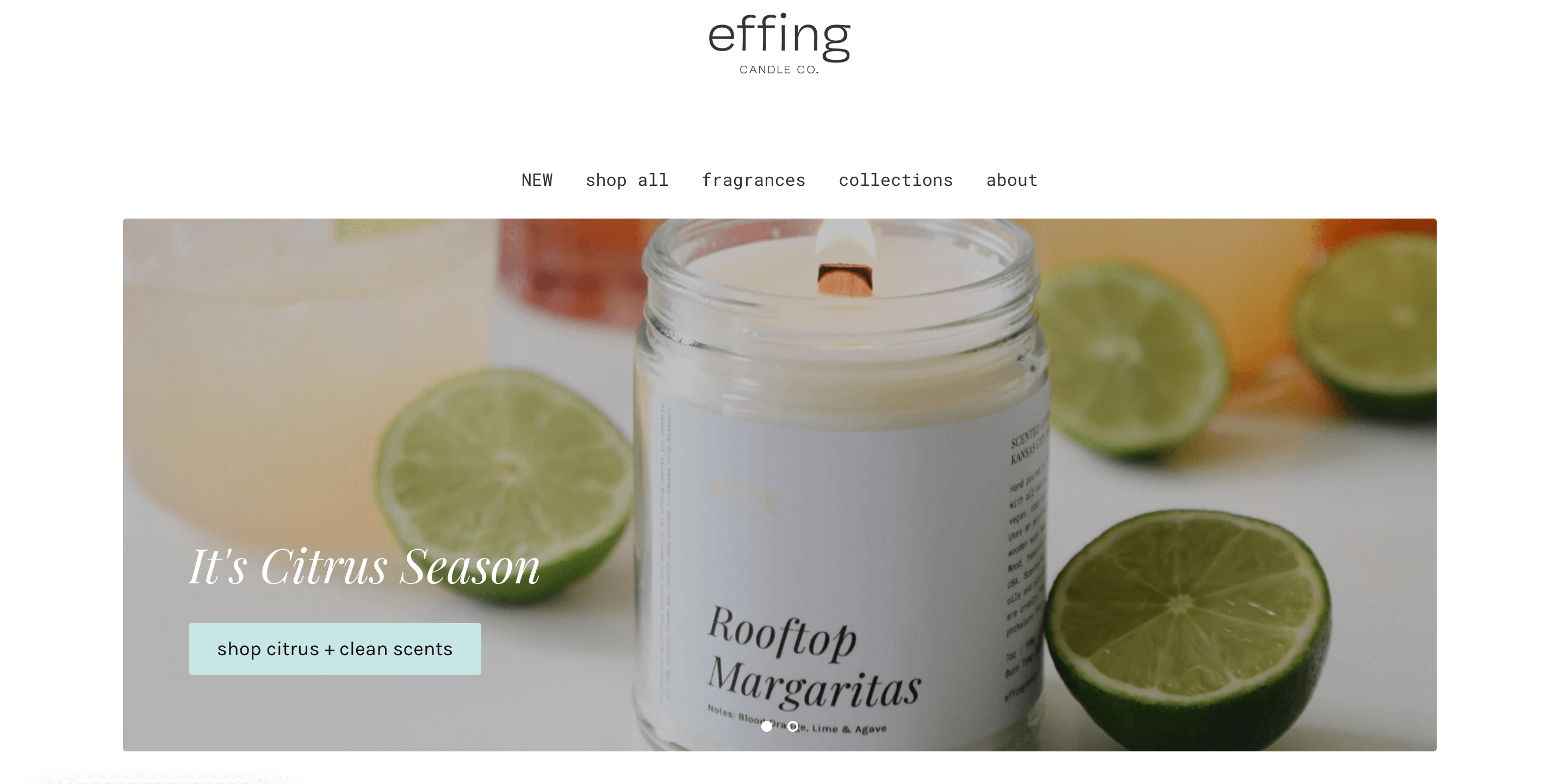 A screenshot from Effing Candle Co.’s homepage of its website. It shows the brand logo, main website menu, and a banner image. The image shows a burning, wood wick candle, with a white, minimalist label that says Rooftop Margaritas. There are several limes surrounding the candle. There is text beside the candle: It’s Citrus Season. Shop citrus and clean scents.