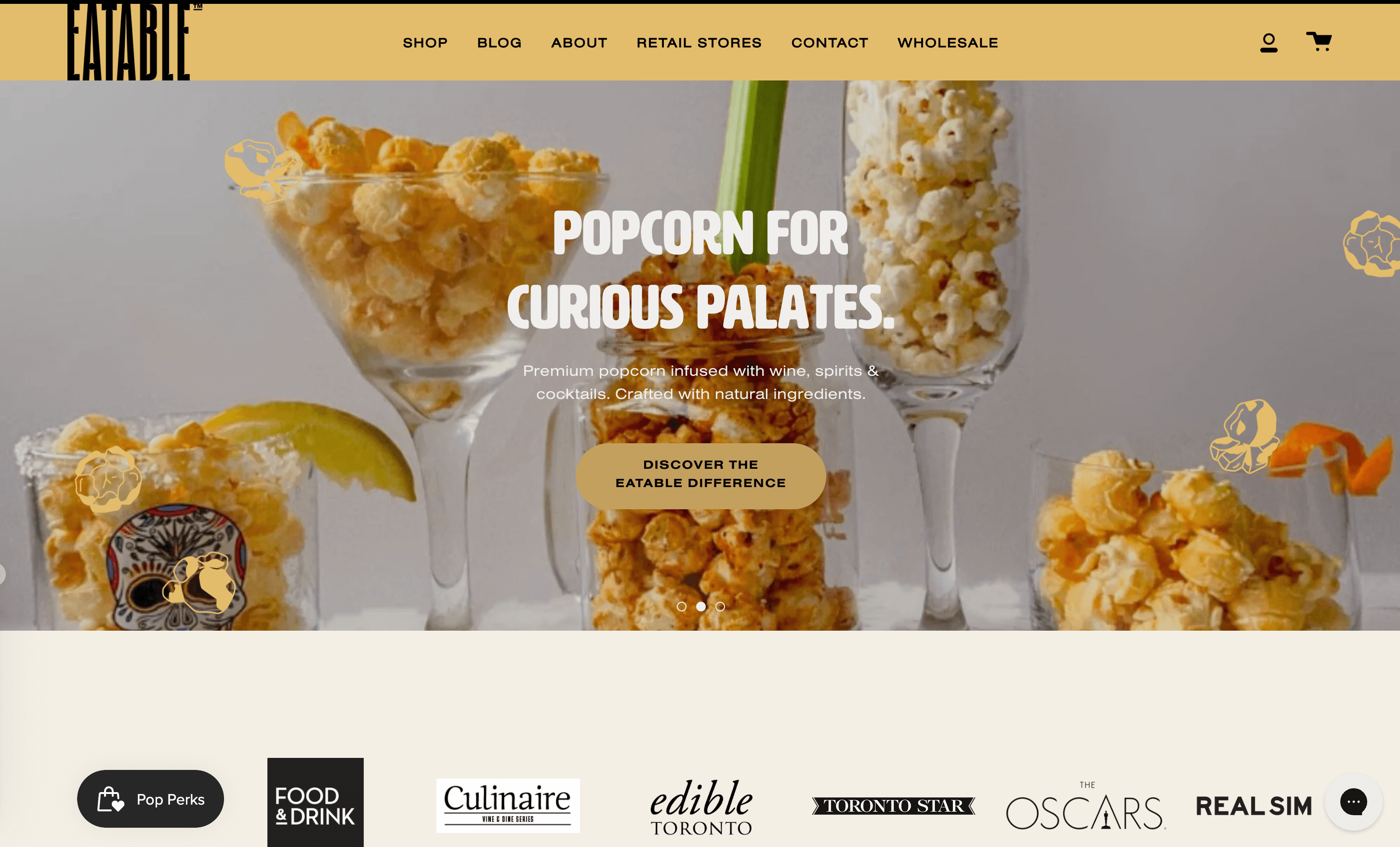 A screenshot of EATABLE’s homepage showing an image of alcohol glasses filled with popcorn. The title reads Popcorn for Curious Palates.&nbsp;