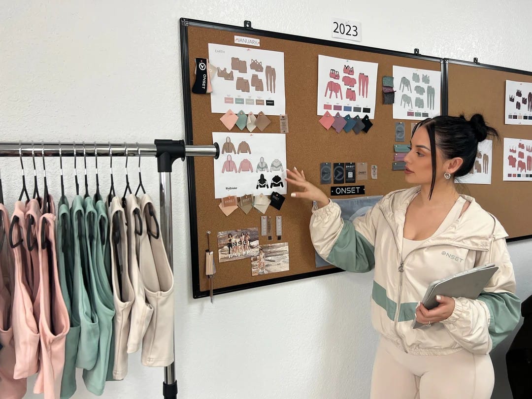 image of latina influencer Les Do Makeup looking at a mood board of her ecommerce brand onset