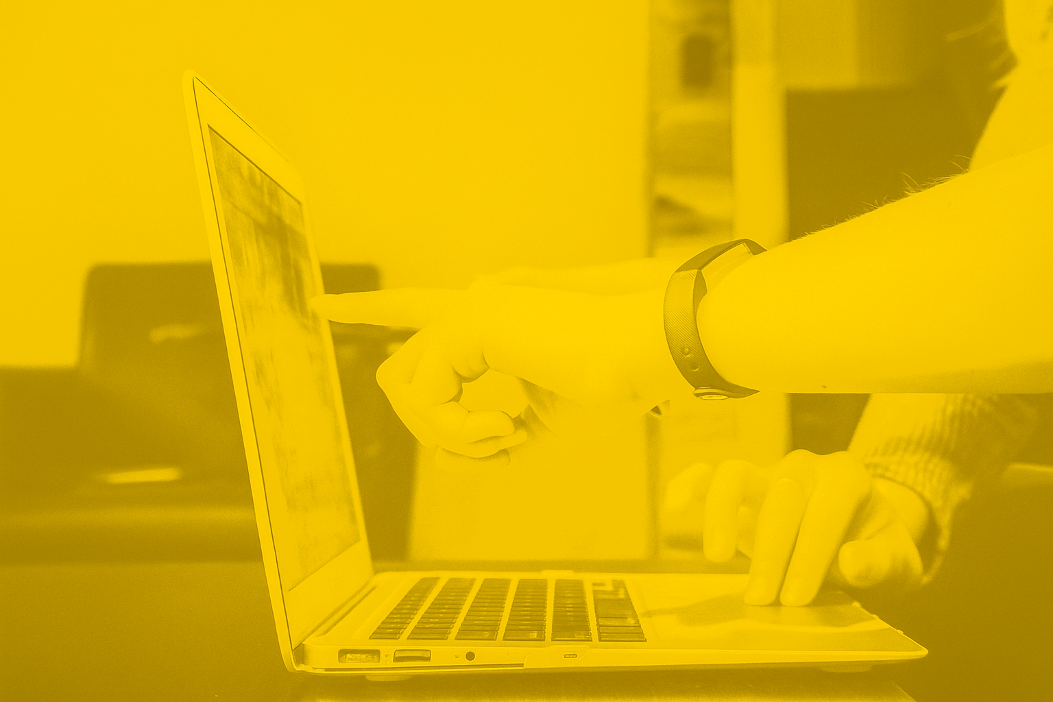 Hands pointing at a laptop screen while browsing loyalty program examples online, shown with Smile.io brand colors