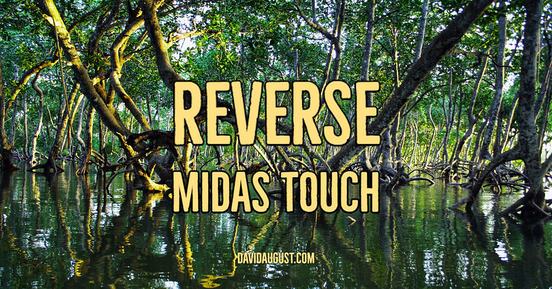 A serene image of a mangrove forest with trees and their roots submerged in calm water, overlaid with the text "REVERSE MIDAS TOUCH" and "DAVIDAUGUST.COM".