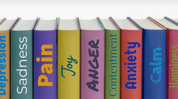 A row of colorful book spines with titles representing various emotions: Depression, Sadness, Pain, Joy, Anger, Contentment, Anxiety, Calm, and Happiness.