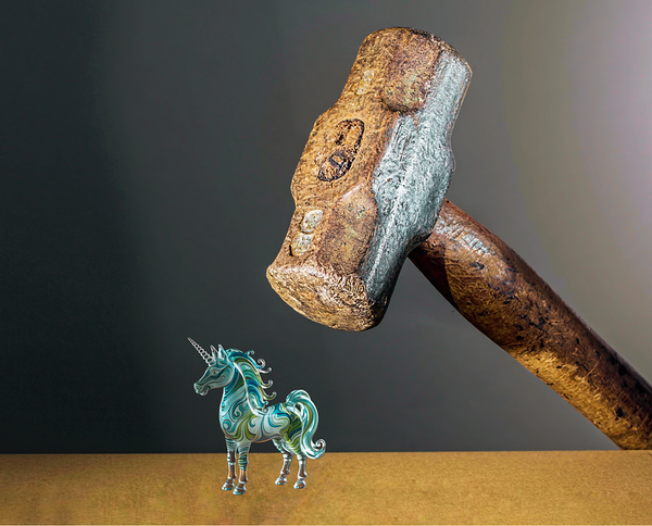 A glass figurine of a unicorn with a colorful, swirling pattern on its body is positioned on a flat surface. Above the unicor