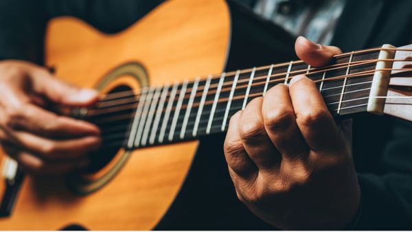 Close up of a Man Playing Acoustic Guitar - Free Download