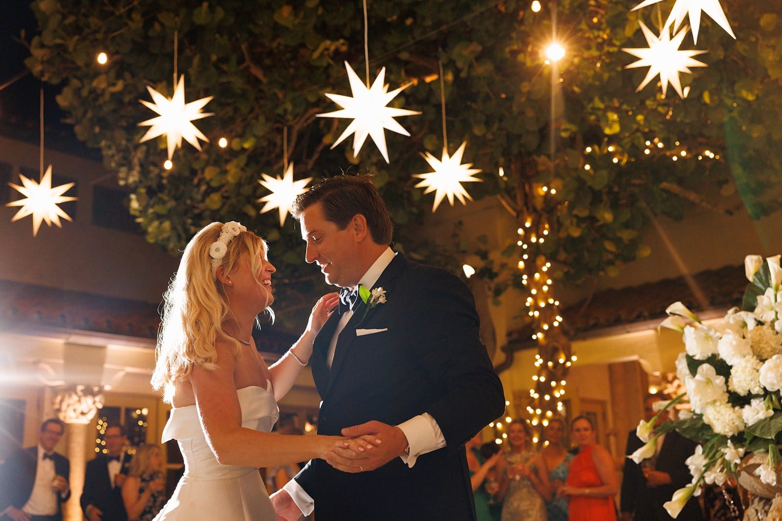 A couple dancing beneath hanging star lanterns