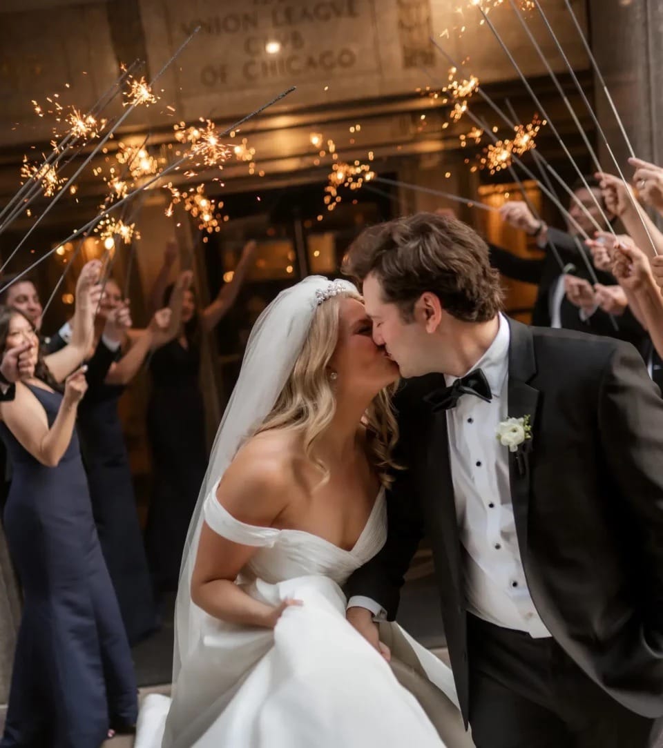 A couple kissing under a canopy of sparklers