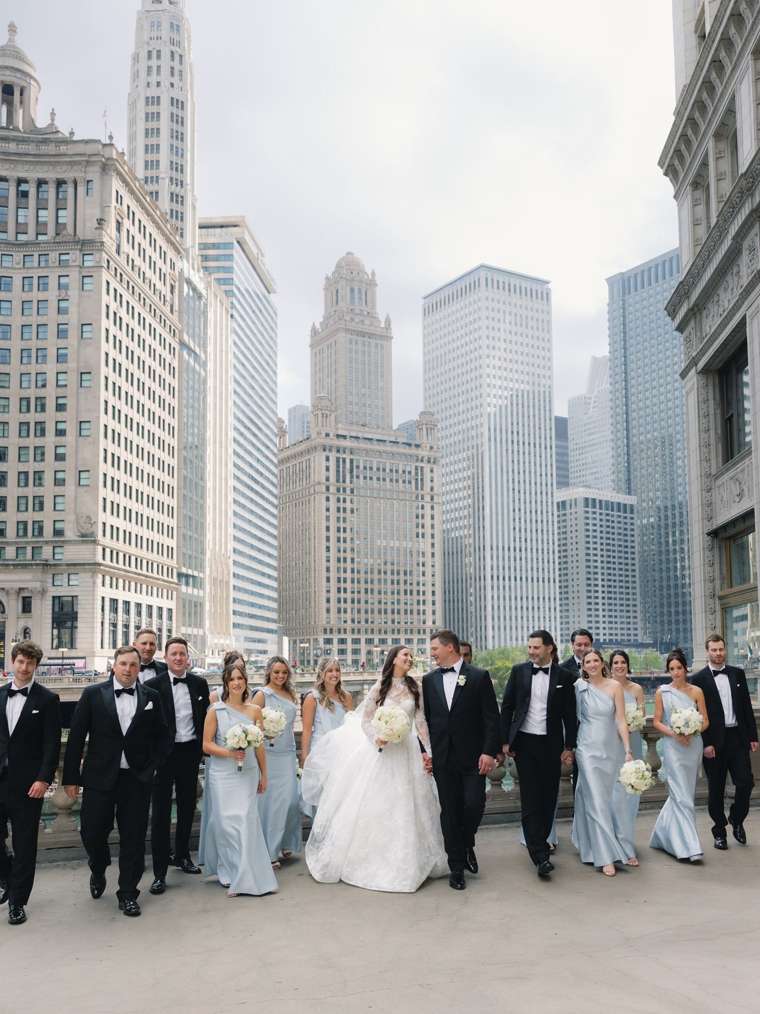 A wedding party on the Chicago riverwalk with the skyline behind