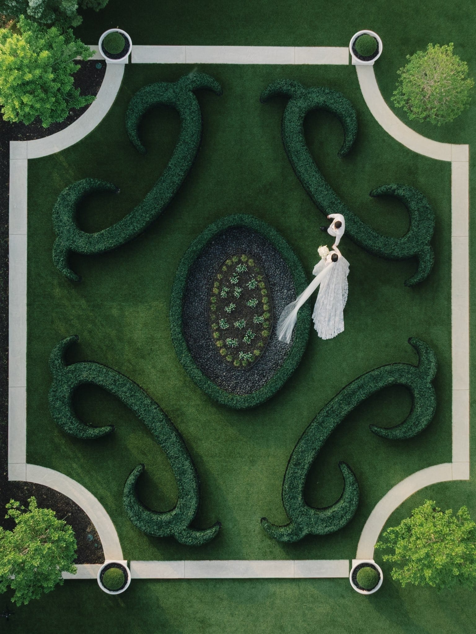 Aerial view of a bride in a formal parterre garden