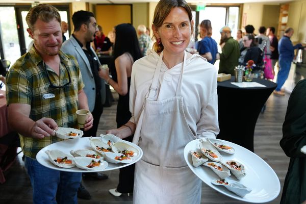 Volunteer, Michele, passing our our Mt. Lassen Lox Crudo on Ceramic Oyster Shells