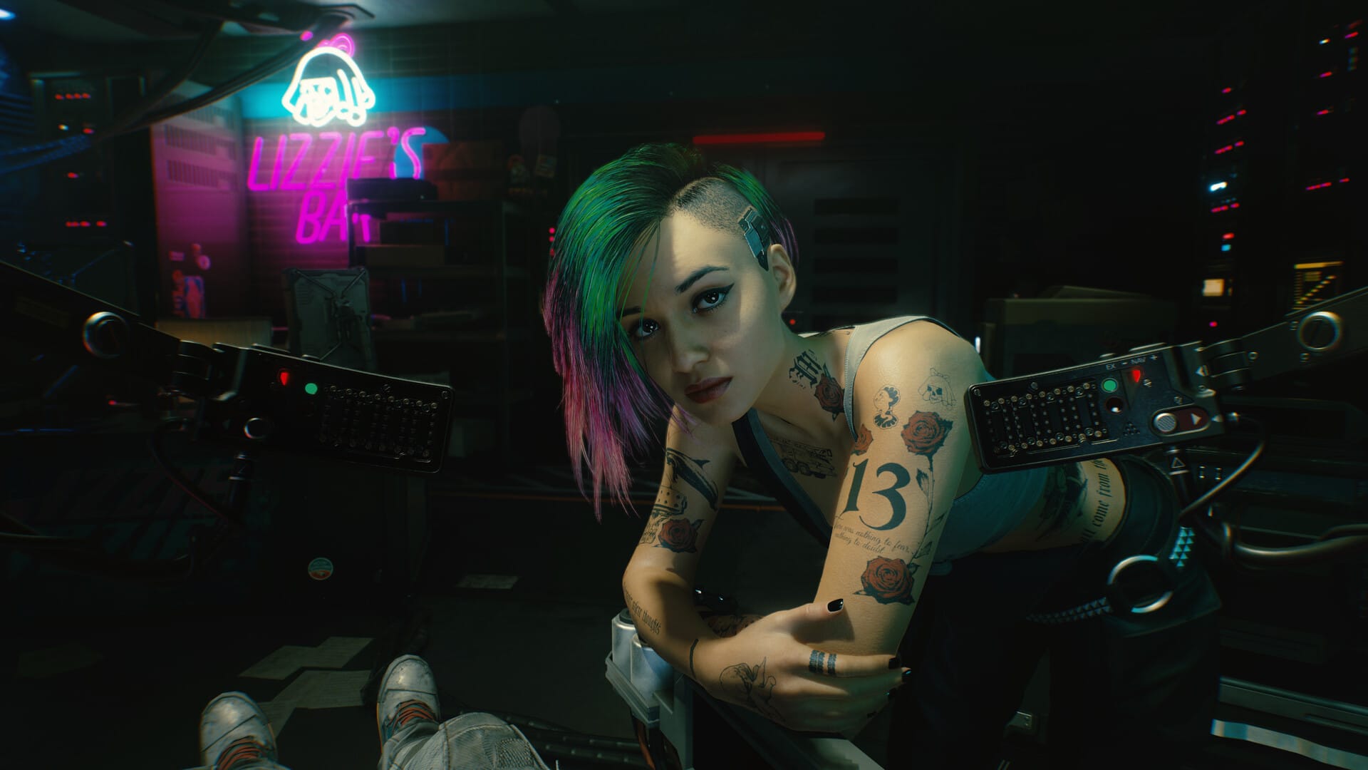 Tattooed woman with green and pink hair looking forward
